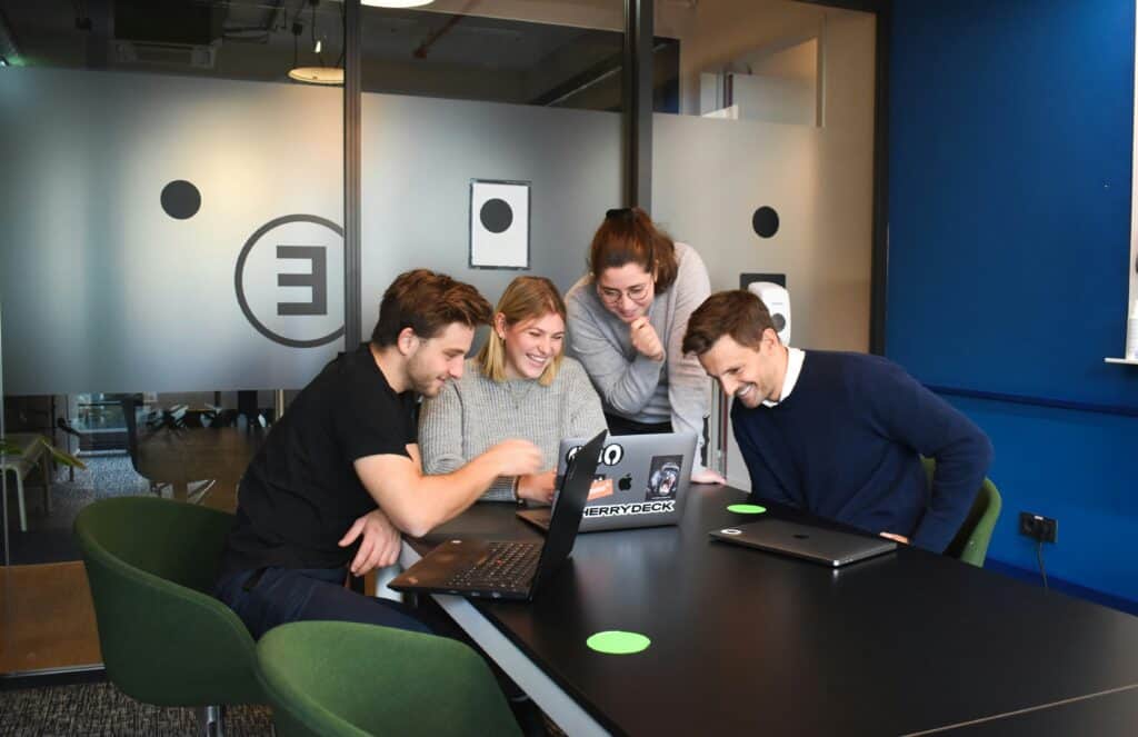 Team of professionals collaborating on a project at Digerati Inc office.
