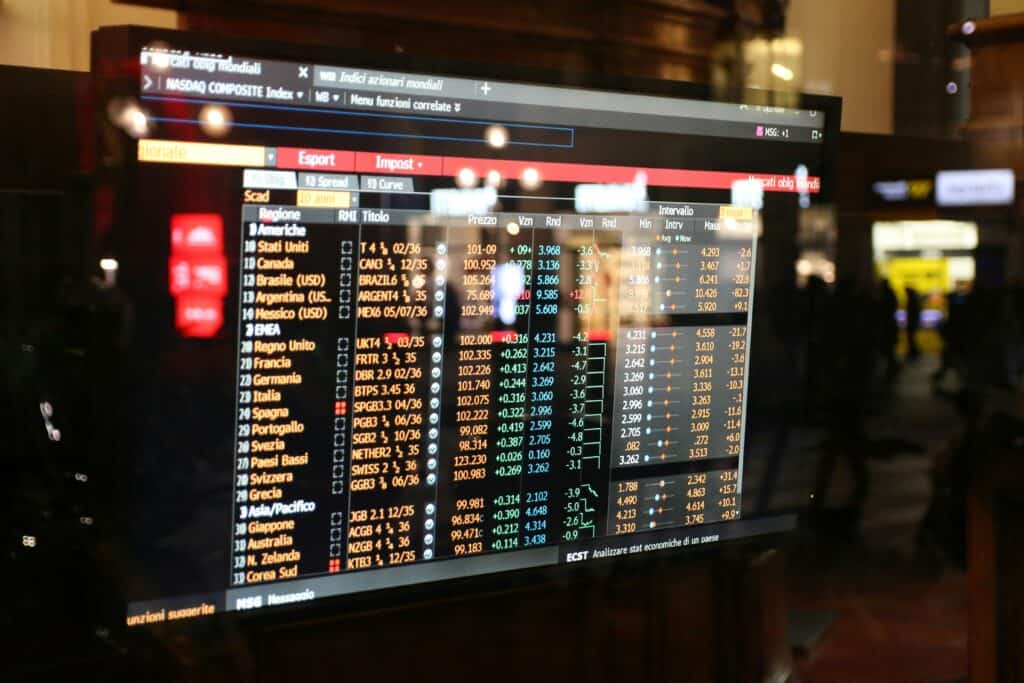 NASDAQ stock market display with financial data and stock prices.