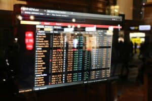 NASDAQ stock market display with financial data and stock prices.