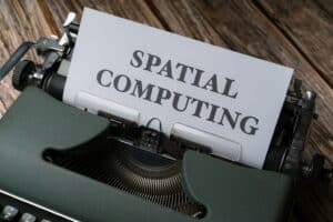 Typewriter with "Spatial Computing" paper, highlighting advanced tech solutions.