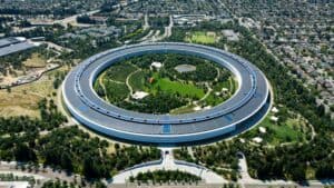Aerial view of Digerati Inc's innovative circular office building in a green park setting.