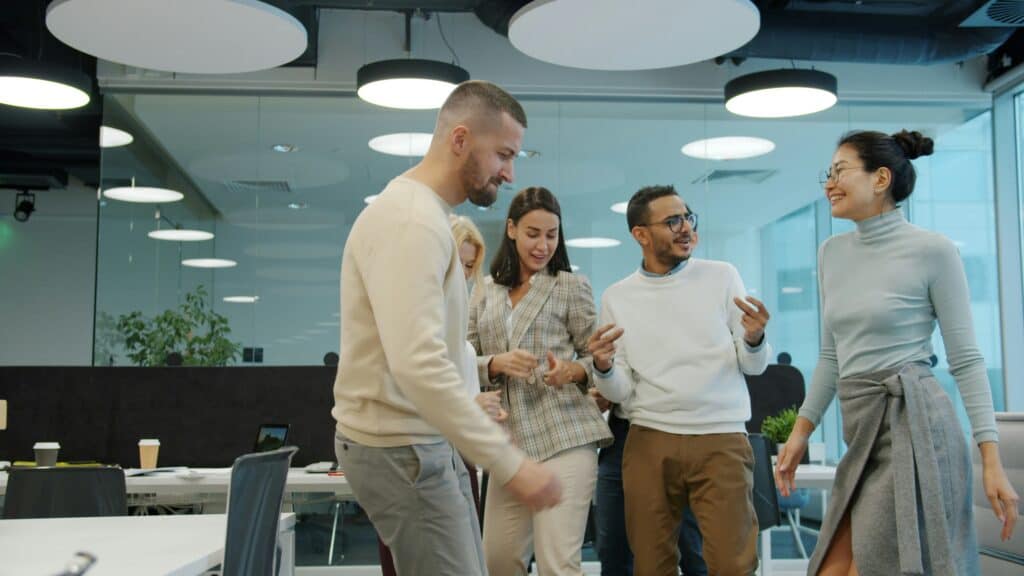 Diverse team celebrating success in a modern office environment.