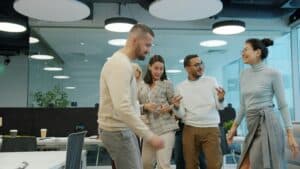 Diverse team celebrating success in a modern office environment.